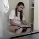 A hidden camera is secretly mounted on an apartment bathroom window sill. It records an attractive girl taking a piss and a shit on a toilet. There is audio, but there ia a crying baby in the background. Over 1.5 minutes.